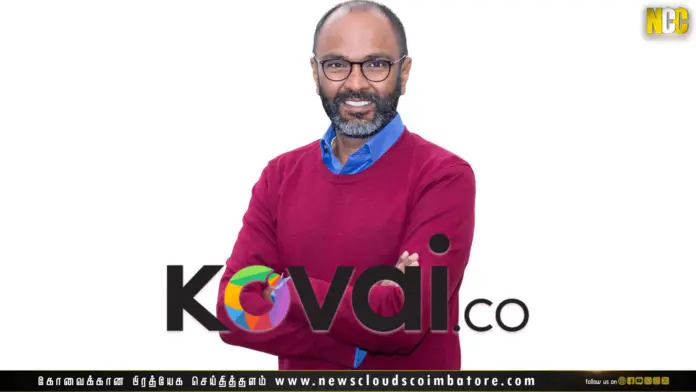 Person wearing red sweater, logo displayed.