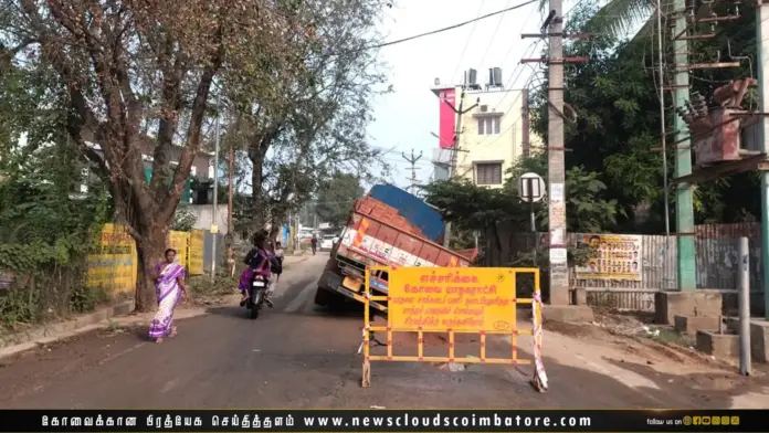 Lorry stuck in sudden road pit on Nallampalayam Road in Coimbatore