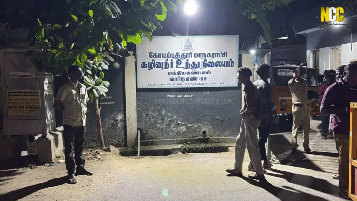 People near a municipal signboard.