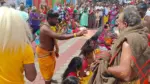 Coimbatore temple festival devotees coconut breaking ritual whip worship ceremony nighttime temple crowd