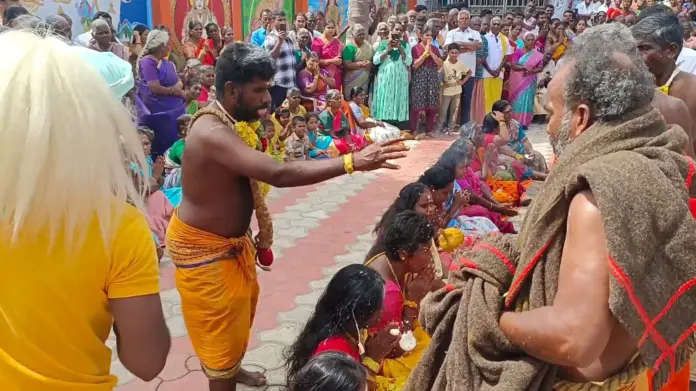 Coimbatore temple festival devotees coconut breaking ritual whip worship ceremony nighttime temple crowd